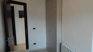 a bathroom with a mirror and a door in a room at Casa la rosa dei venti in Cardedu