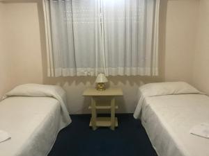 Una cama o camas en una habitación de Hotel Coliseo