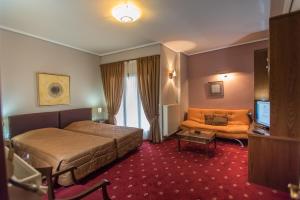 Кровать или кровати в номере City Hotel Apollonion