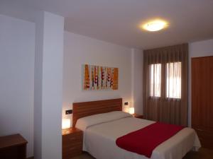 Cama o camas de una habitación en Apartamentos Puerta Muralla