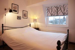 una camera con un letto bianco e una finestra di Kings Cross Apartments a Londra