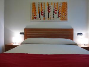 Cama o camas de una habitación en Apartamentos Puerta Muralla