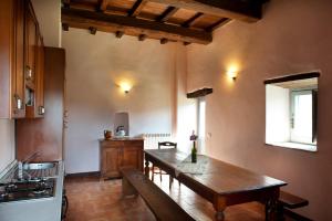 a kitchen with a wooden table in a room at Tenuta San Felice in Giano dellʼUmbria