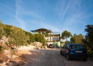 a blue car parked in front of a house at Bellavista Peljesac Peninsula in Dubrava