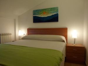 Cama o camas de una habitación en Apartamentos Puerta Muralla