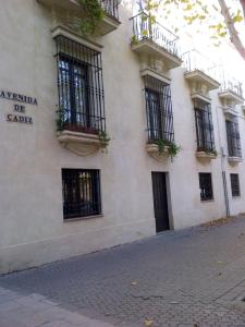 a white building with balconies on the side of it at Apartamentos Murallas de Sevilla in Seville