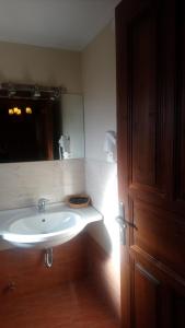 a bathroom with a sink and a mirror at Hotel Pelasgos in Karítaina