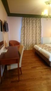Postel nebo postele na pokoji v ubytování Hotel Pelasgos