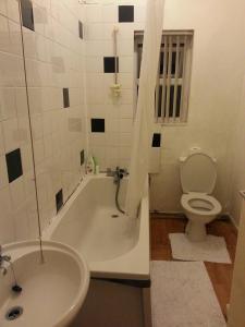 a bathroom with a tub and a toilet and a sink at Double Room Home Stay Manchester in Manchester