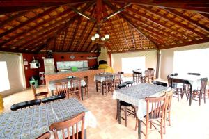 una zona pranzo con tavoli e sedie in un ristorante di Pousada Akonxego a Olímpia
