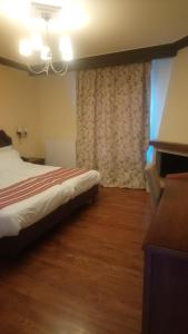 Hotel Pelasgos tesisinde bir odada yatak veya yataklar
