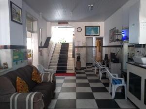a living room with a couch and a checkered floor at Hotel Britânia in Ilhéus