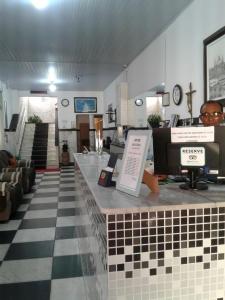 a store with a checkered floor and a counter at Hotel Britânia in Ilhéus