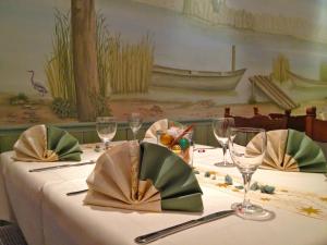 a table with a white table cloth with wine glasses at Die Hardtmühle in Bergfreiheit