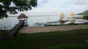 a view of a lake with a group of umbrellas at Hotel Bruno's Place in El Remate