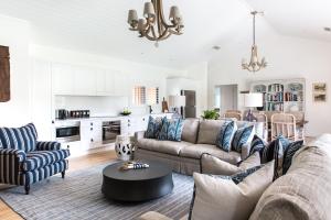 a living room with a couch and a table at Bendooley Estate in Berrima