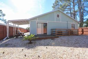 a small house with a porch and a patio at House 3 blocks to the beach in Panama City Beach