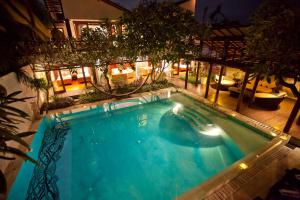 a swimming pool in the middle of a house at Villa Casis by Nagisa Bali in Sanur