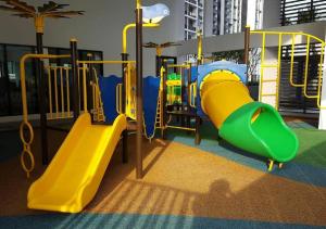 a playground with a yellow and green slide at NAT i-city smart house in Shah Alam