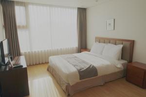 Postel nebo postele na pokoji v ubytování Vabien Suite 1 Serviced Residence