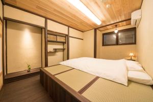 a bedroom with a large bed in a room at Kyoto style small inn Iru in Kyoto
