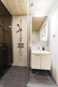 een badkamer met een douche en een wastafel bij Kylväjänkuja Apartments in Vantaa