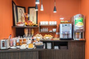 a counter with food on it in a restaurant at Hotel Victoria Lyon Perrache Confluence in Lyon