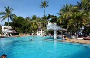 a group of people swimming in a large swimming pool at Turtle Bay Beach Club- All Inclusive in Watamu