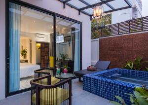 a patio with a pool and a table and chairs at King Rock Residence in Siem Reap