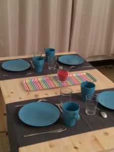 a table with blue plates and glasses on it at Chez Fanny in La Flocellière