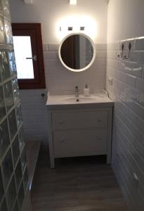a bathroom with a sink and a mirror at Cozy Townhouse Altea in Altea +15 photos