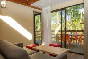 a living room with a couch and a table at VTF Les Oyats Sylvadoures in Maubuisson