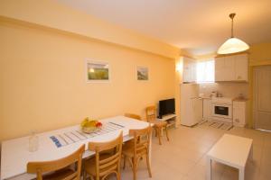 a kitchen and dining room with a table and chairs at Paros Parikia house in Parikia