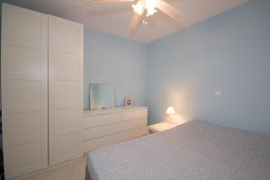 a bedroom with a bed and a ceiling fan at Paros Parikia house in Parikia +16 photos