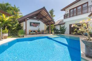 a villa with a swimming pool and a house at Villa Origami by Nagisa Bali in Seminyak +29 photos