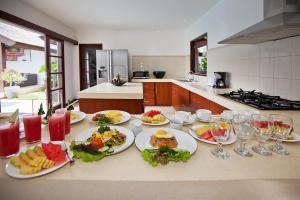 a kitchen with plates of food on a counter at Villa Origami by Nagisa Bali in Seminyak