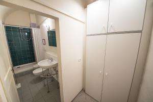 a bathroom with a sink and a toilet and a shower at Appartamento i Priori in Volterra +13 photos