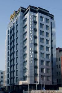 a large building with a hotel sign on it at The Corporate Hotel in Ulaanbaatar