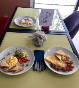 a table with two plates of breakfast food on it at Non-stop Economy hotel in Boryspilʼ