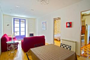 a room with a bed and a couch and a table at La Lleona Apartment in Girona