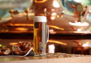 a glass of beer and some donuts on a table at Hotel Sachsenklemme in Fortezza