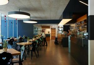 a restaurant with tables and chairs and a person in the background at Hotel Sachsenklemme in Fortezza
