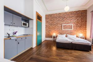 a bedroom with a bed and a brick wall at HolidayPark Mlázovy in Kolinec