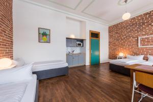 a bedroom with two beds and a brick wall at HolidayPark Mlázovy in Kolinec