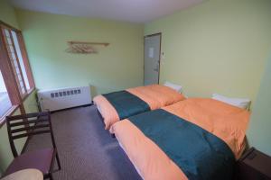 Кровать или кровати в номере Aspen Shiga
