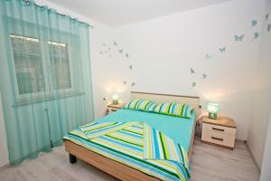 Postel nebo postele na pokoji v ubytování Apartman Diana