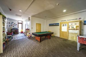 a living room with a pool table in it at Crocus Apartments 310, 507 in Štrbské Pleso