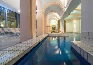 a swimming pool in a building with blue water at Grand Hotel Rogaška Premium in Rogaška Slatina