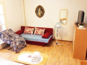 a living room with a couch and a chair at Apartman Gracin in Primošten