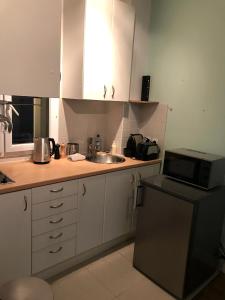 a small kitchen with a sink and a microwave at My Trip in Paris - Turgot in Paris